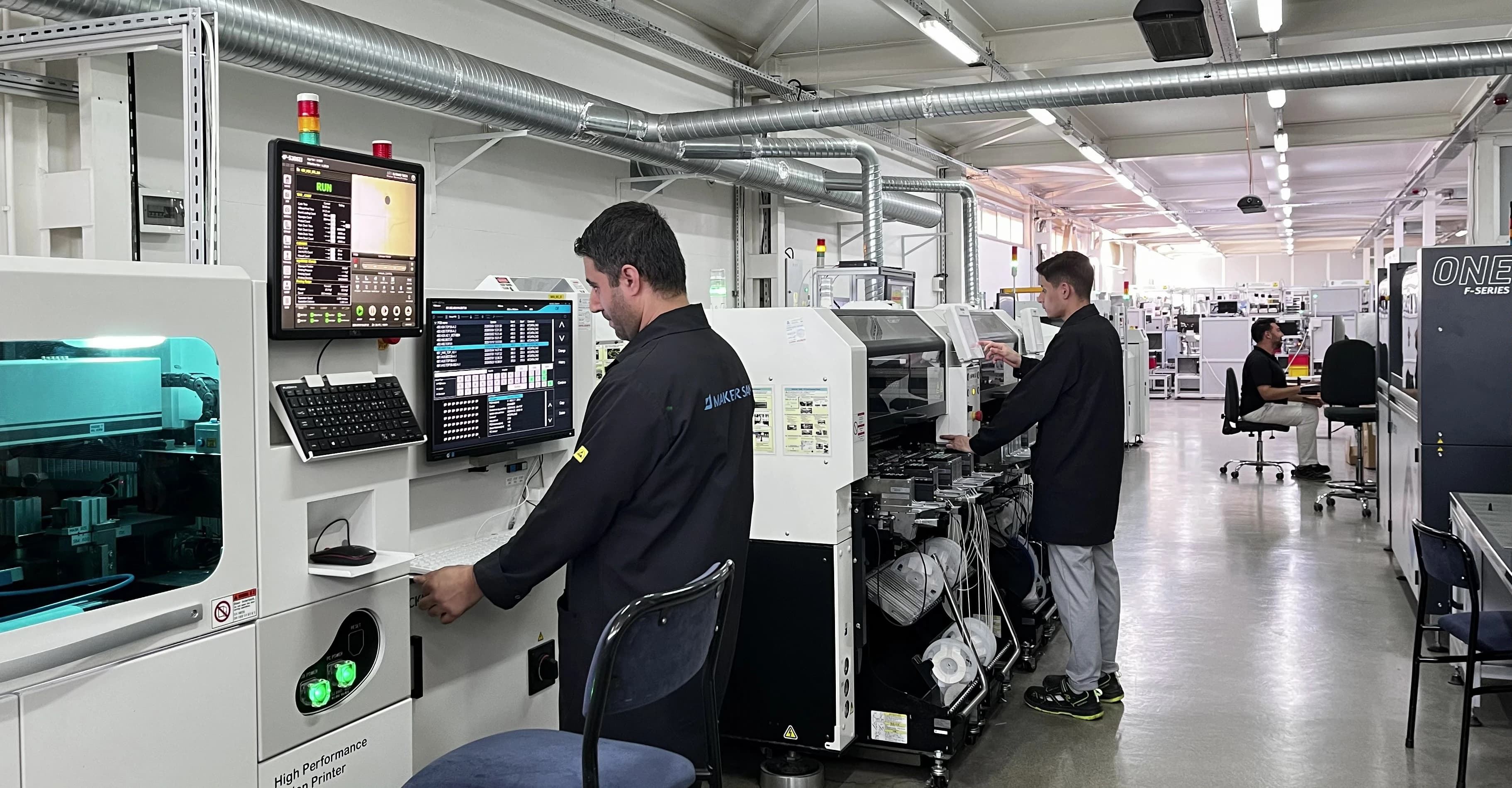 Operators working along Makersan's electronics production hall