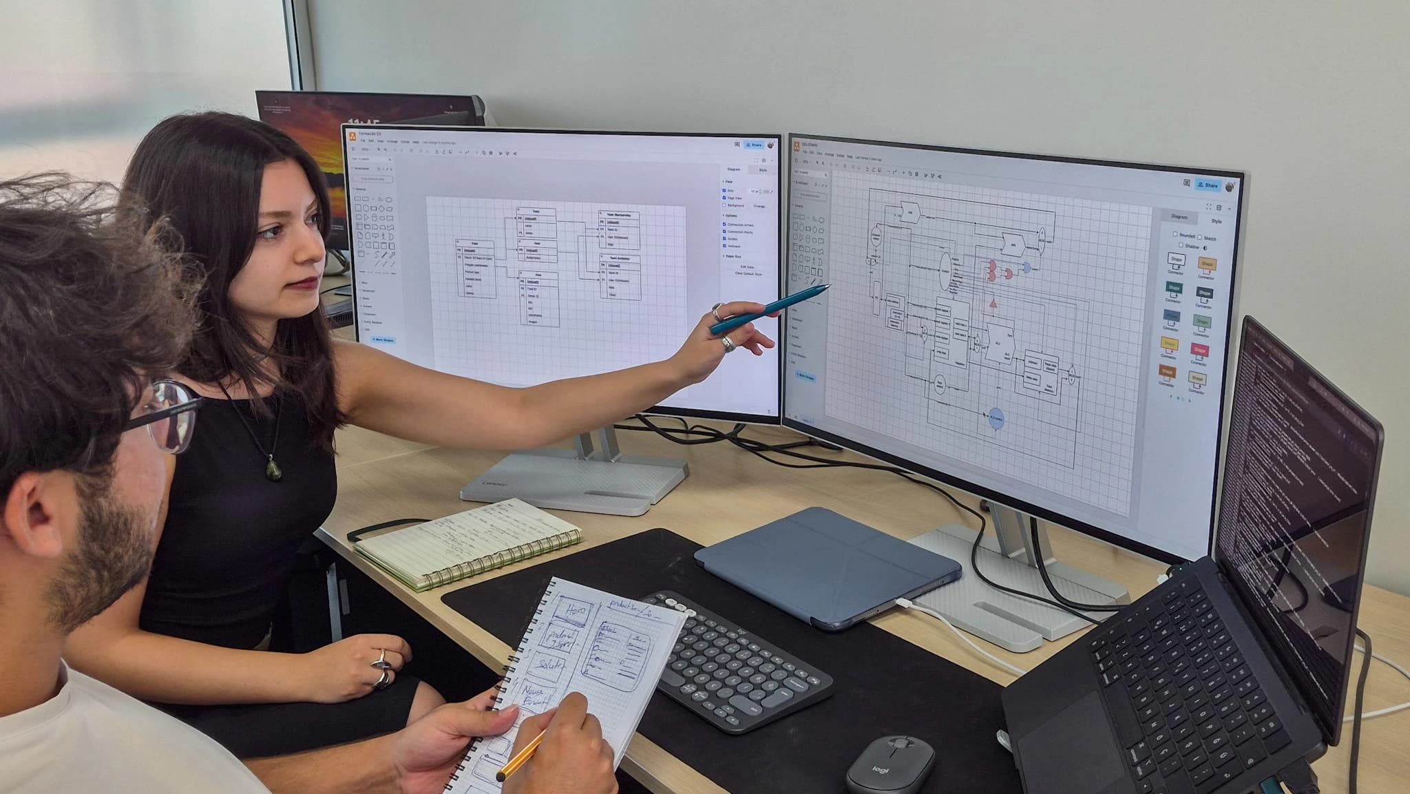 Engineer reviewing a 3D board model beside oscilloscope and HMI hardware