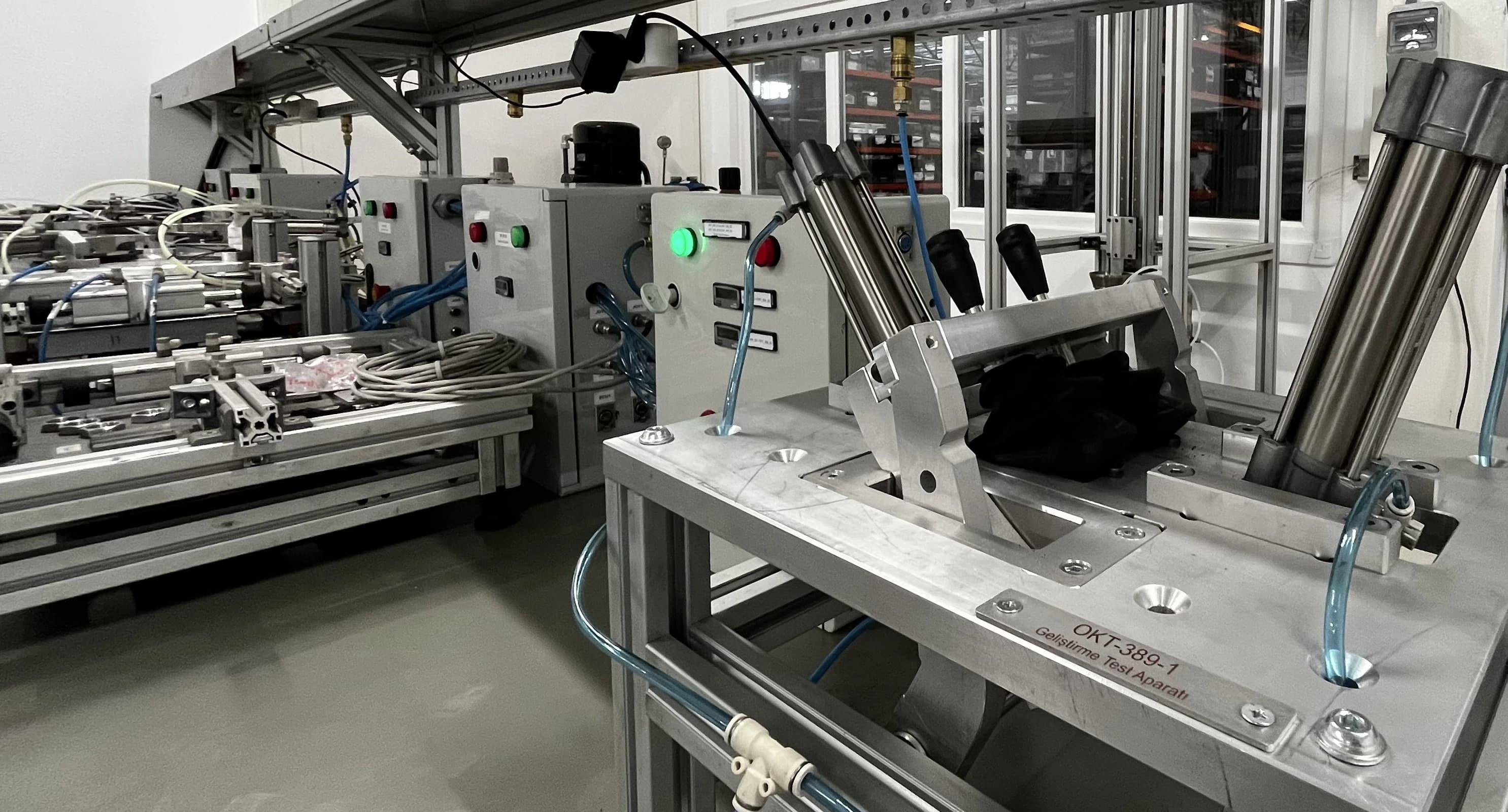Pneumatic endurance rig built in-house, cycling lever assemblies on the Makersan test floor