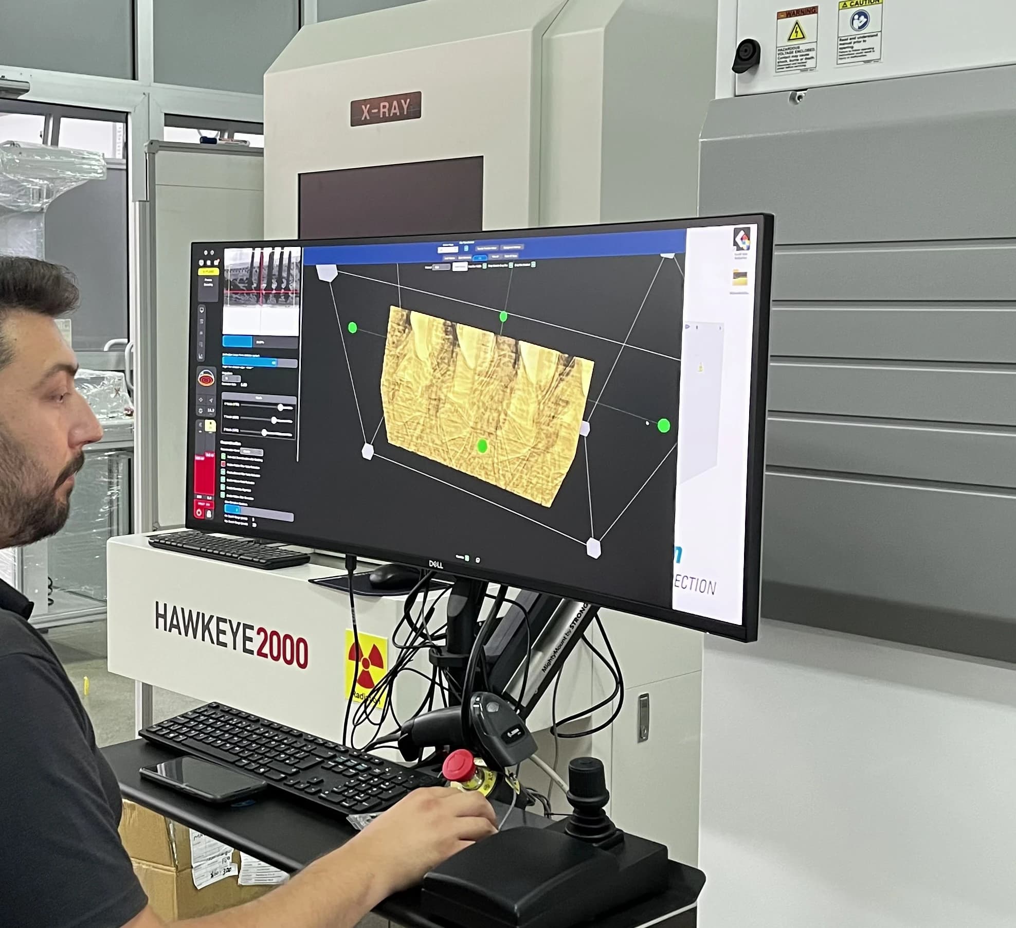 Engineer reviewing an X-ray reconstruction of solder joints at the Hawkeye 2000 inspection cabinet