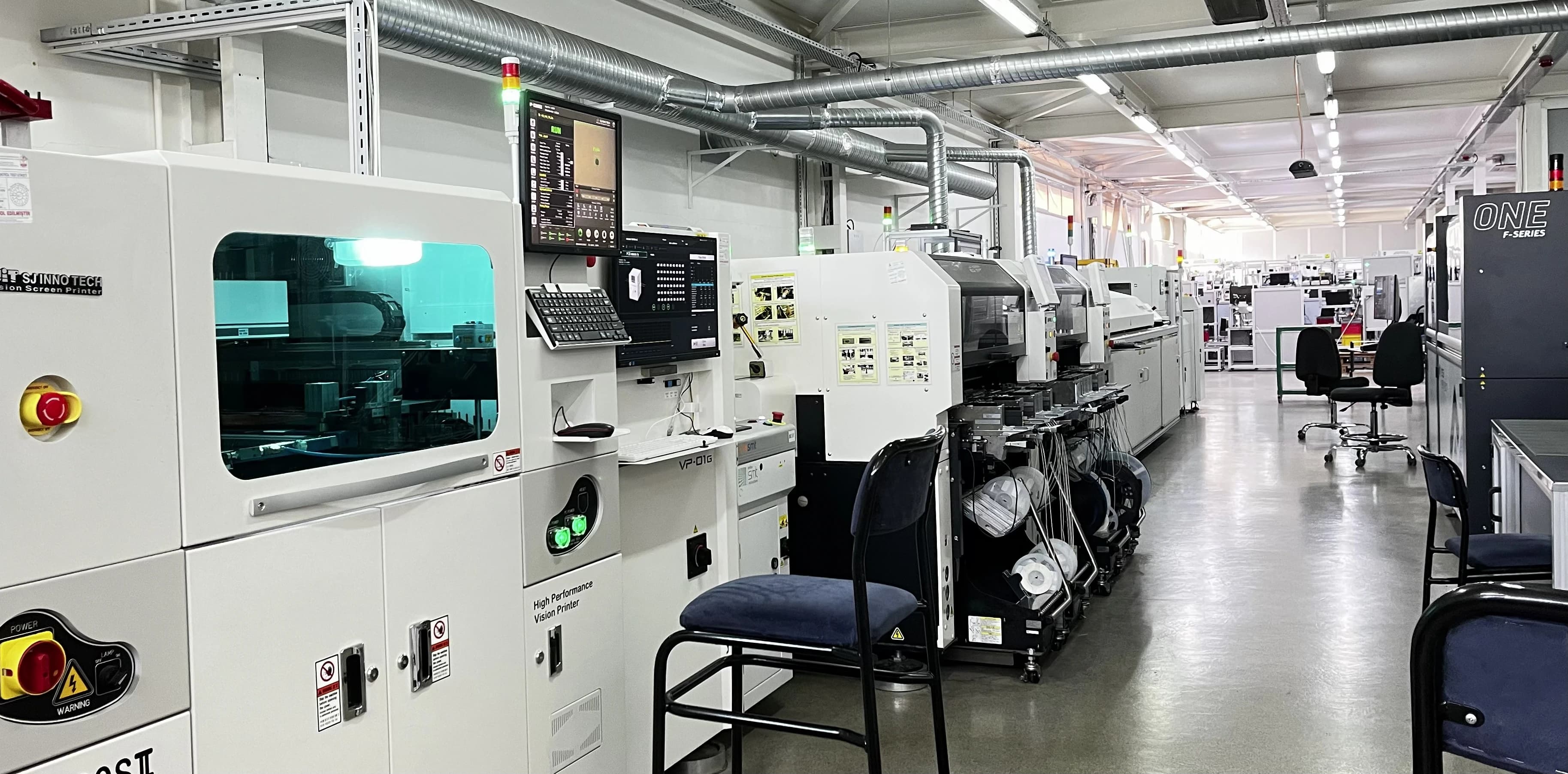 Circuit boards passing through a placement machine on the Makersan SMT line